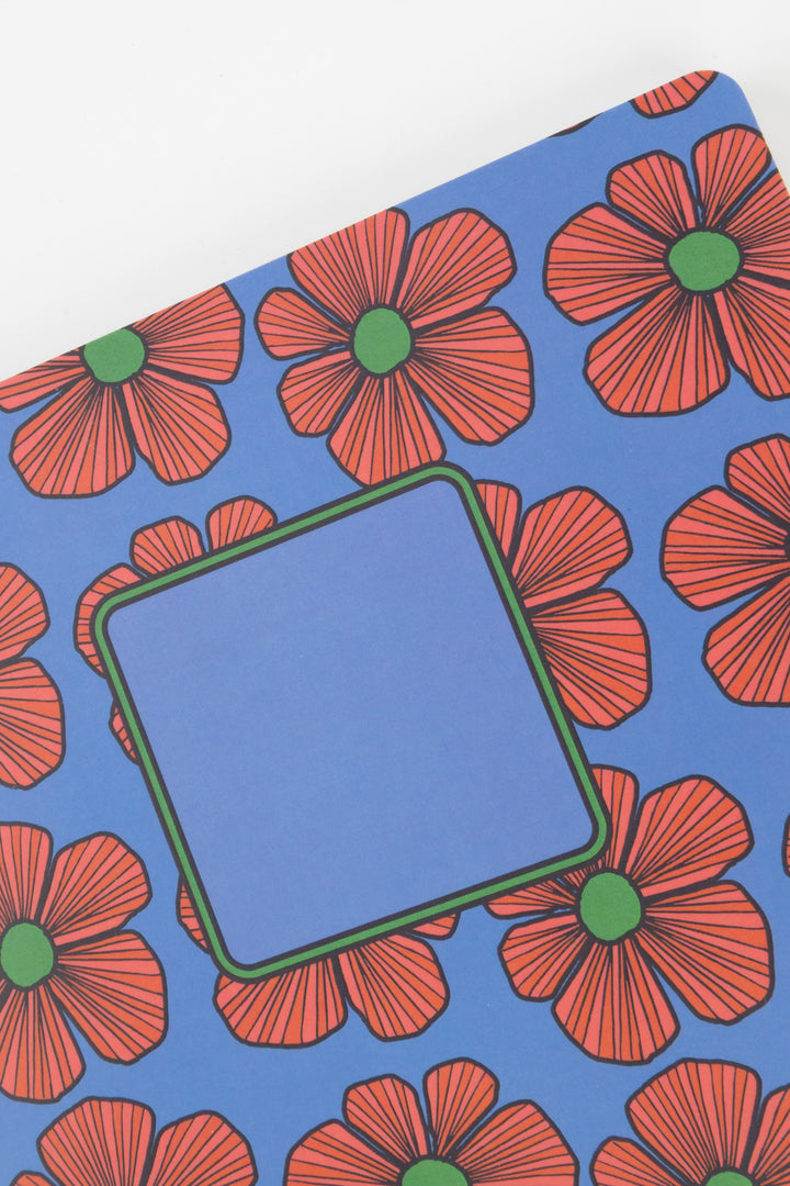 Notebook with red floral pattern on a blue background