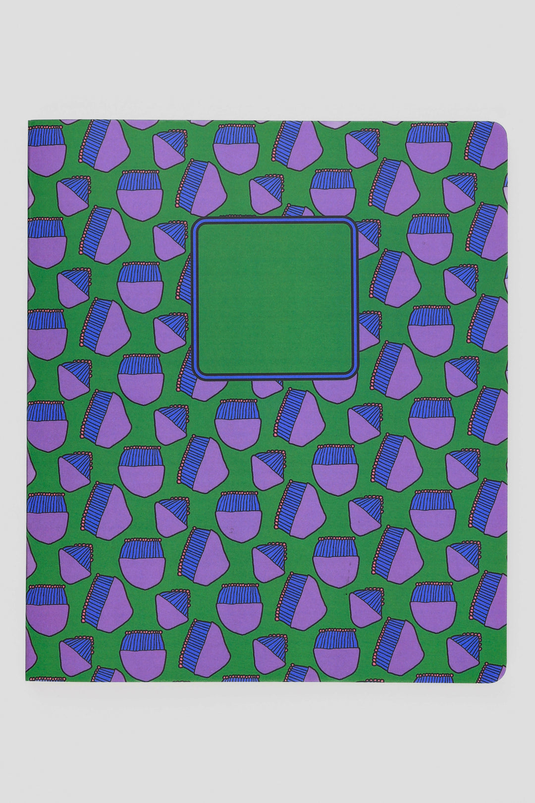 Notebook with a green and purple geometric pattern on a white background