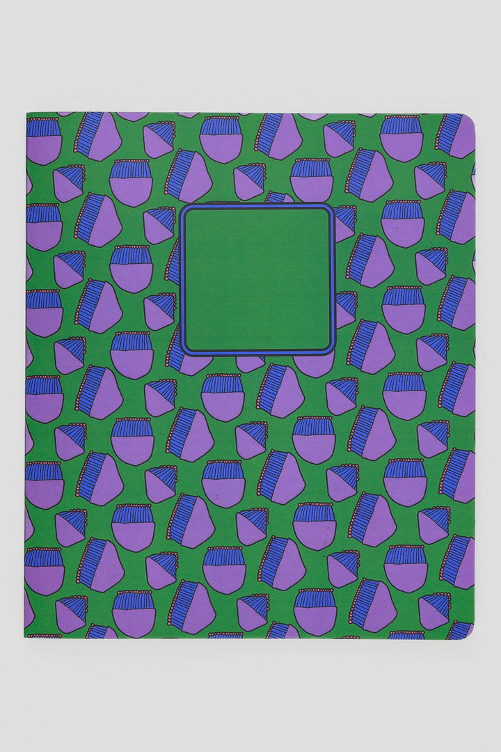 Notebook with a green and purple geometric pattern on a white background