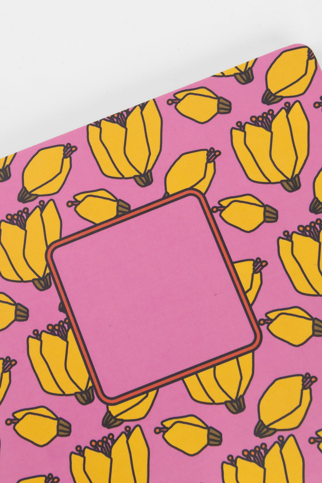 notebook with banana pattern on a pink background