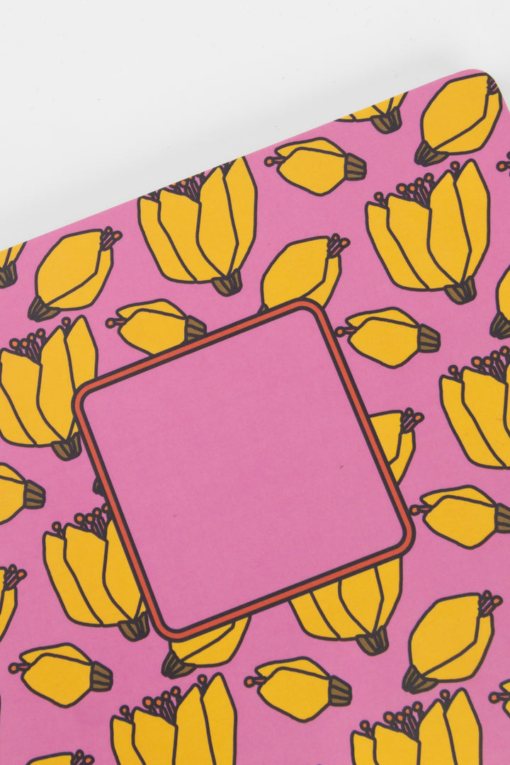notebook with banana pattern on a pink background