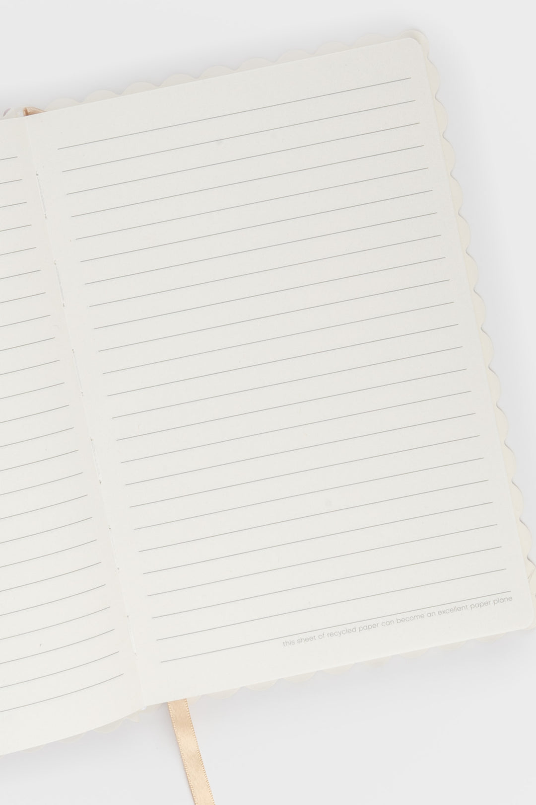Close-up of a notebook with lined pages on a white background