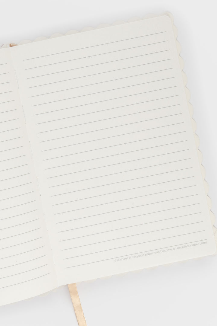 Close-up of a notebook with lined pages on a white background