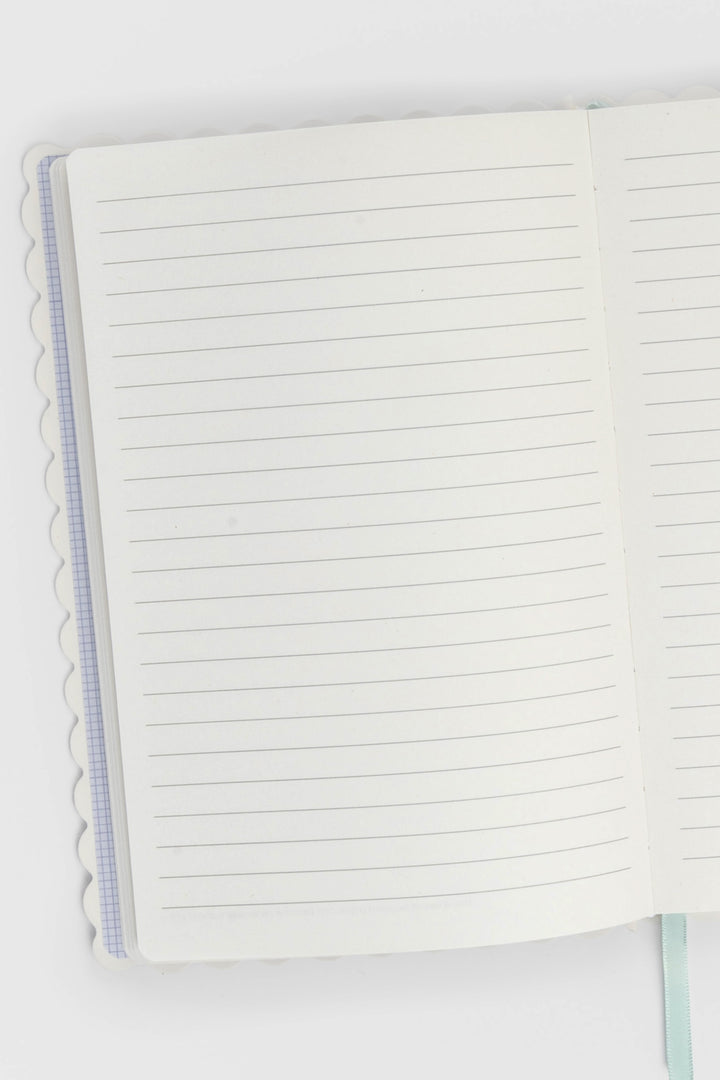 open notebook showing lined pages with scalloped edges visible on the left side