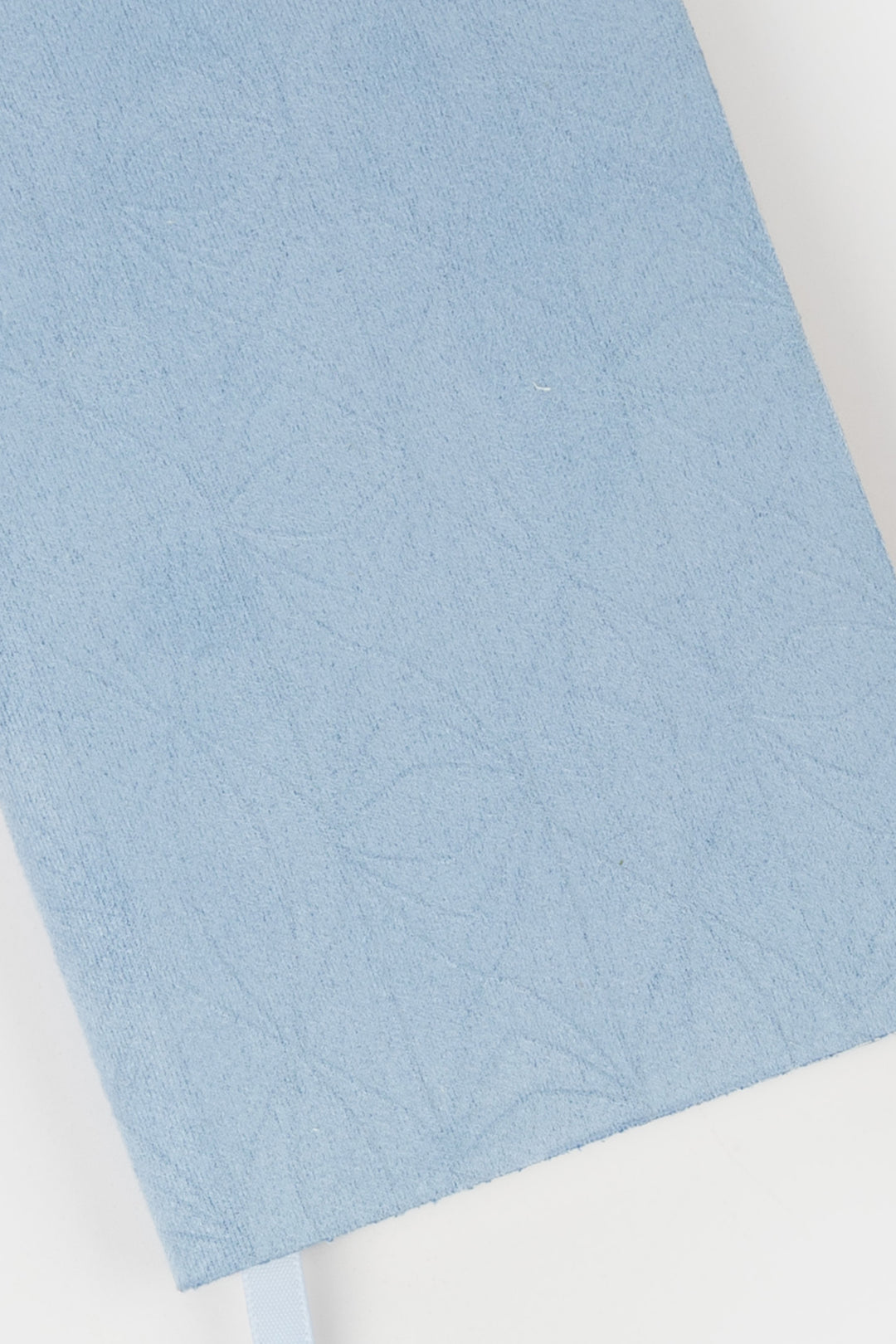 detail of blue faux suede  flex-cover diary with embossed pattern 
