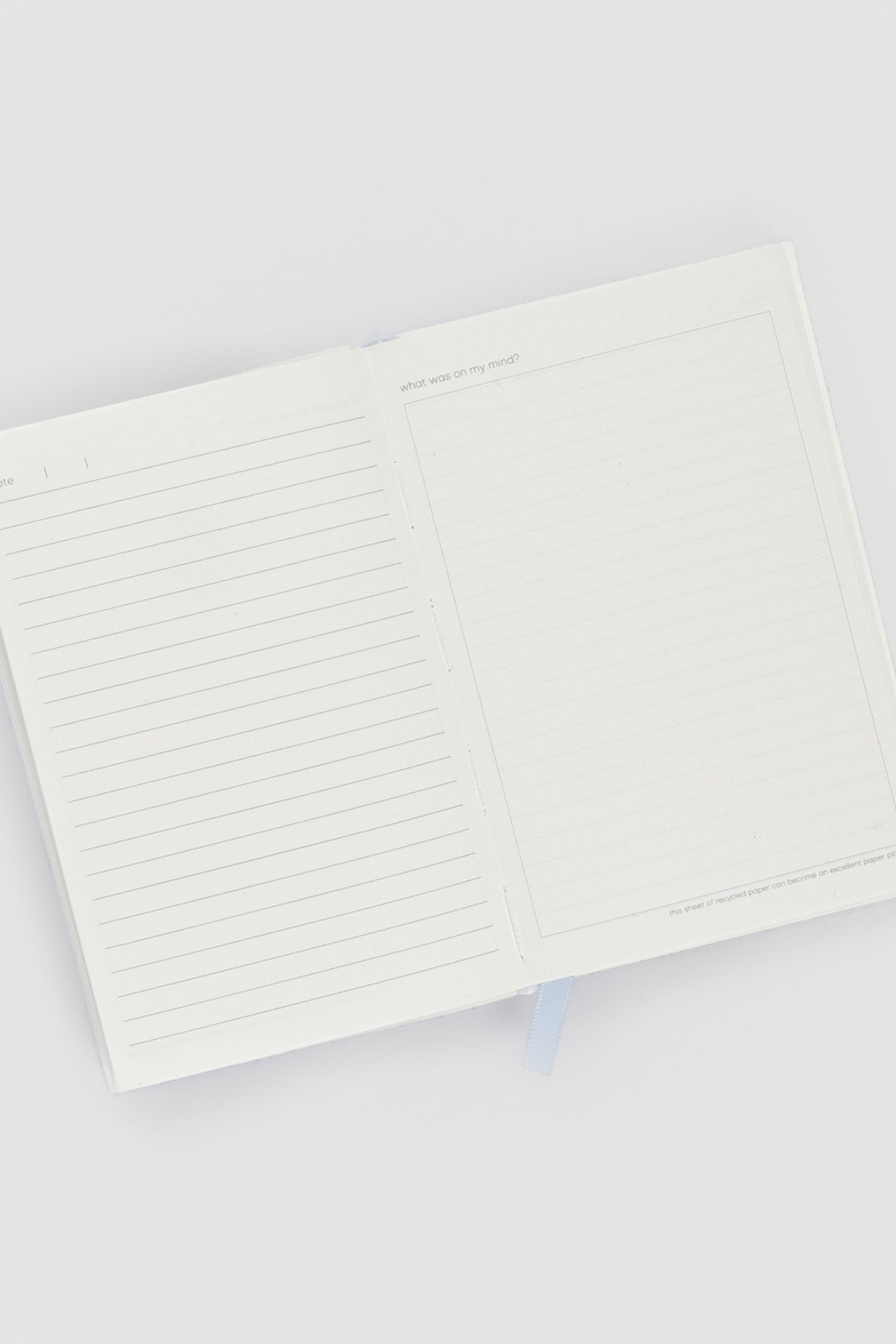 open diary with lined pages on the left and blank doodle page on the right
