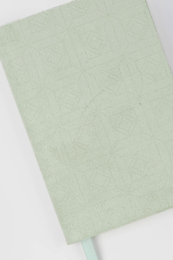 detail of green faux suede  flex-cover diary with embossed pattern 

