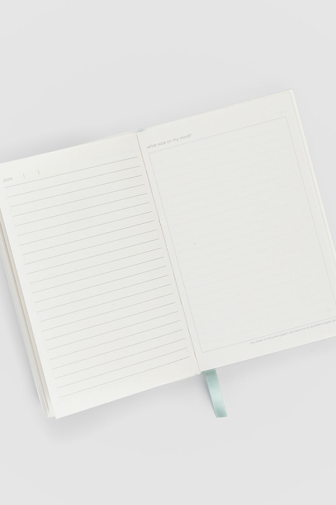 open diary with lined pages on the left and blank doodle page on the right
