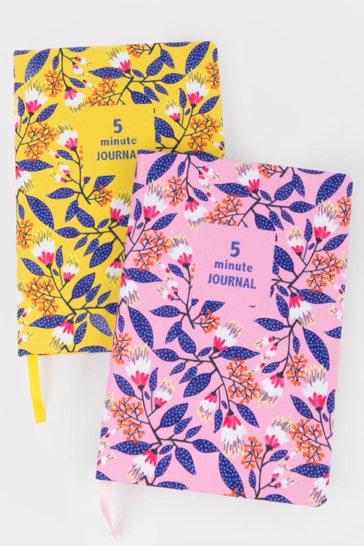 a5 five minute journal in pink floral print next to the yellow version
