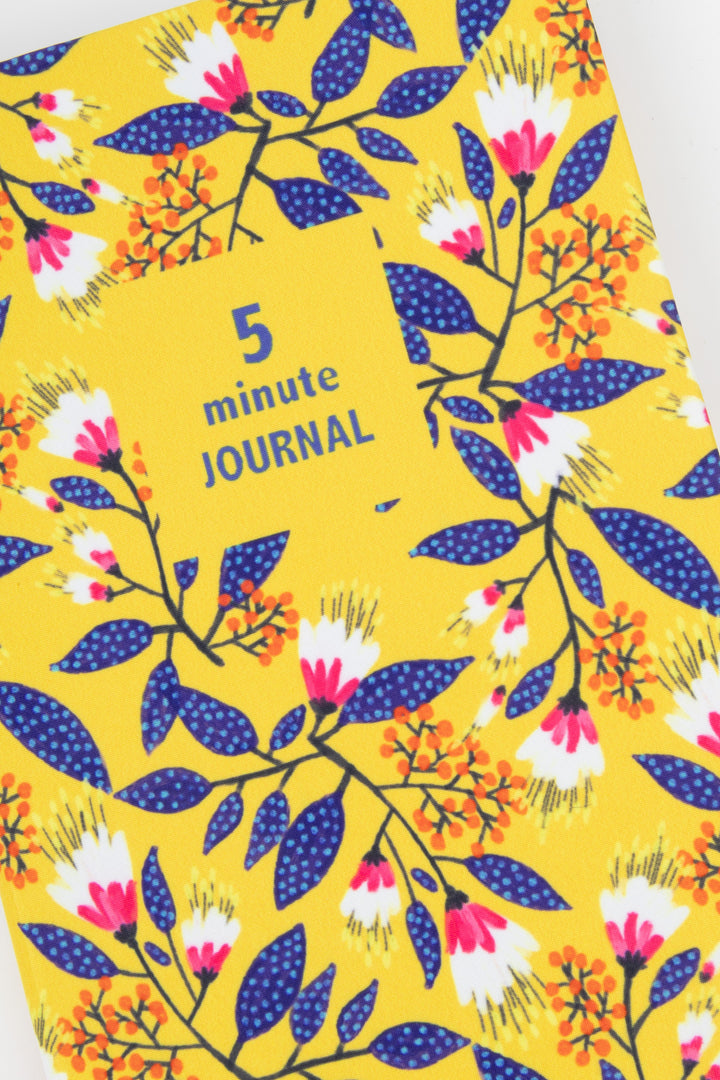 close up of yellow floral fabric cover showing five minute journal title block
