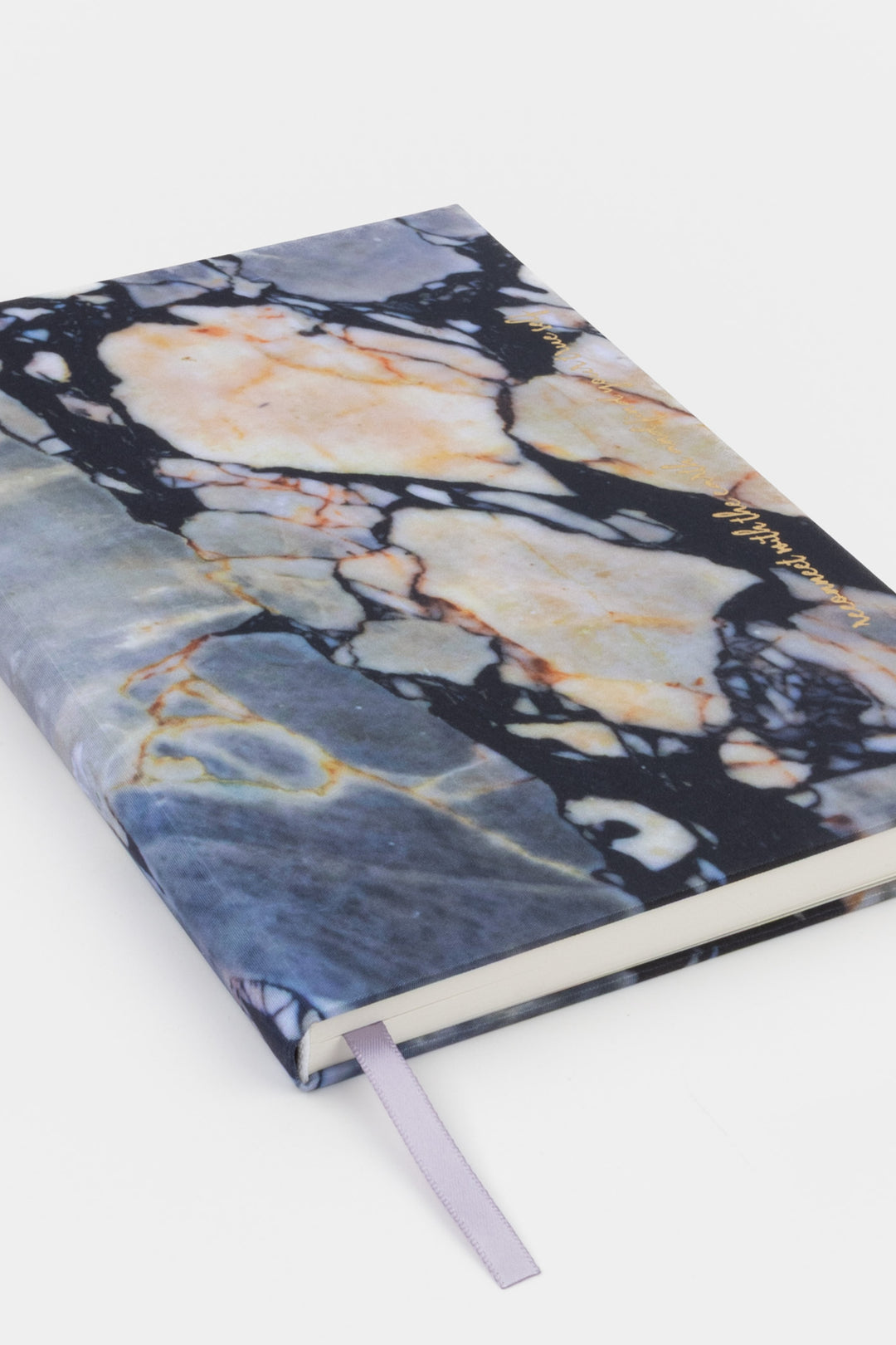 A5 diary with fabric cover featuring natural stone print, closed angled view with ribbon bookmark