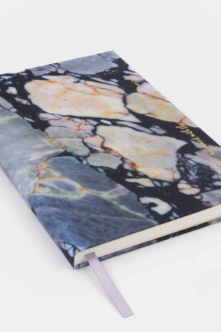 A5 diary with fabric cover featuring natural stone print, closed angled view with ribbon bookmark