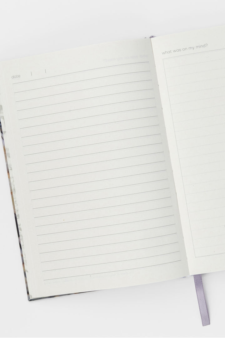 Open A5 diary showing lined and blank journal pages and ribbon bookmark