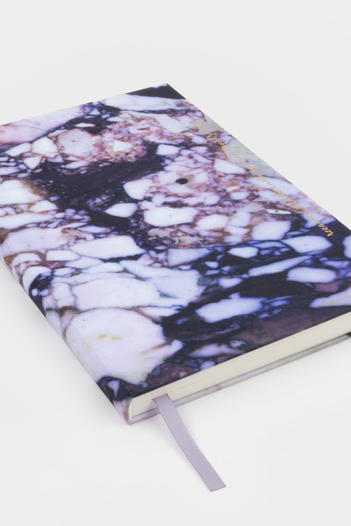 A5 diary with fabric cover featuring natural stone print, closed angled view with ribbon bookmark