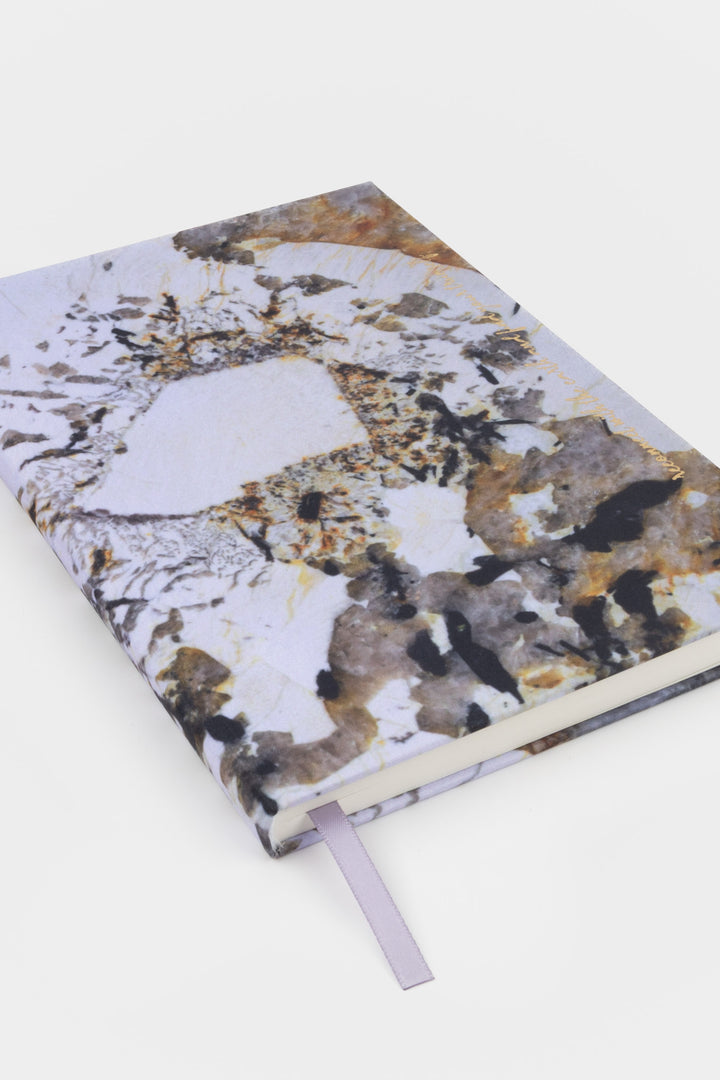 A5 diary angled view showing natural stone print cover and spine with ribbon bookmark