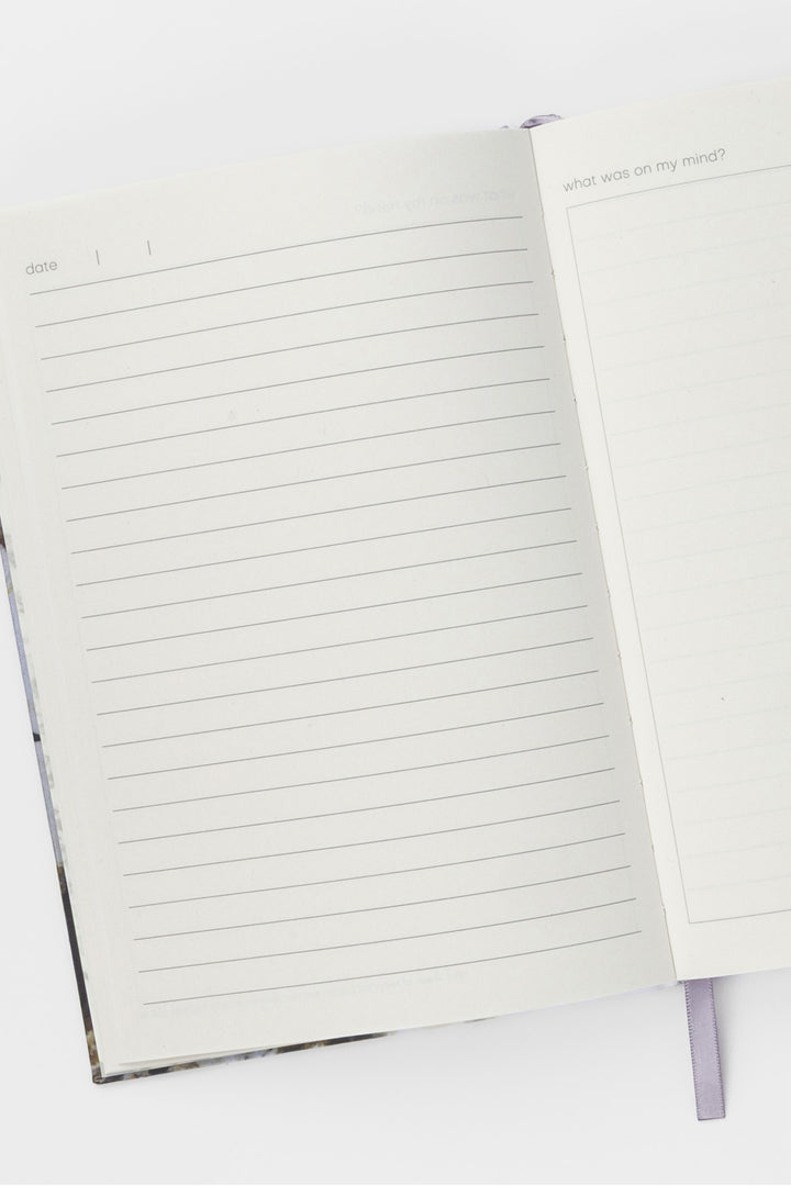 Open A5 diary showing lined pages with ribbon bookmark visible