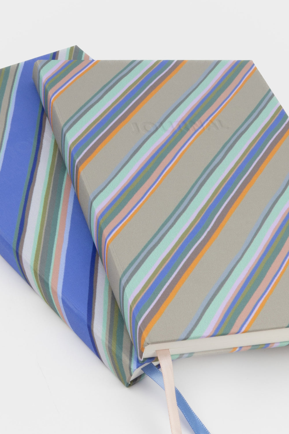 Striped fabric with blue, green, and orange colors on a white background