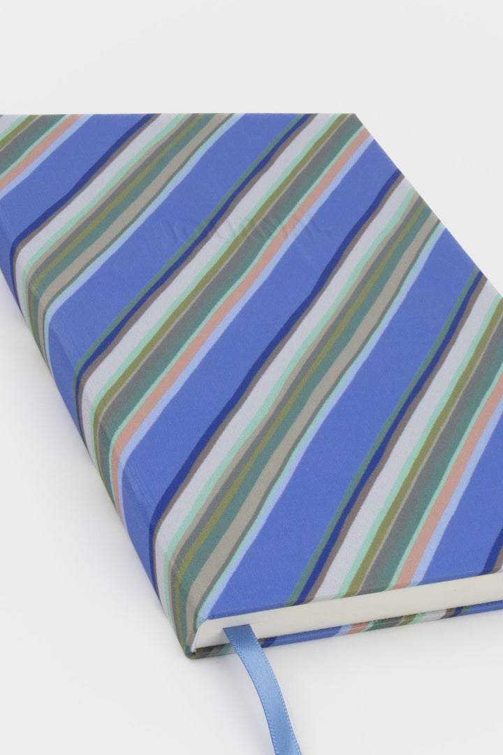 Notebook with blue and green striped cover on a white background