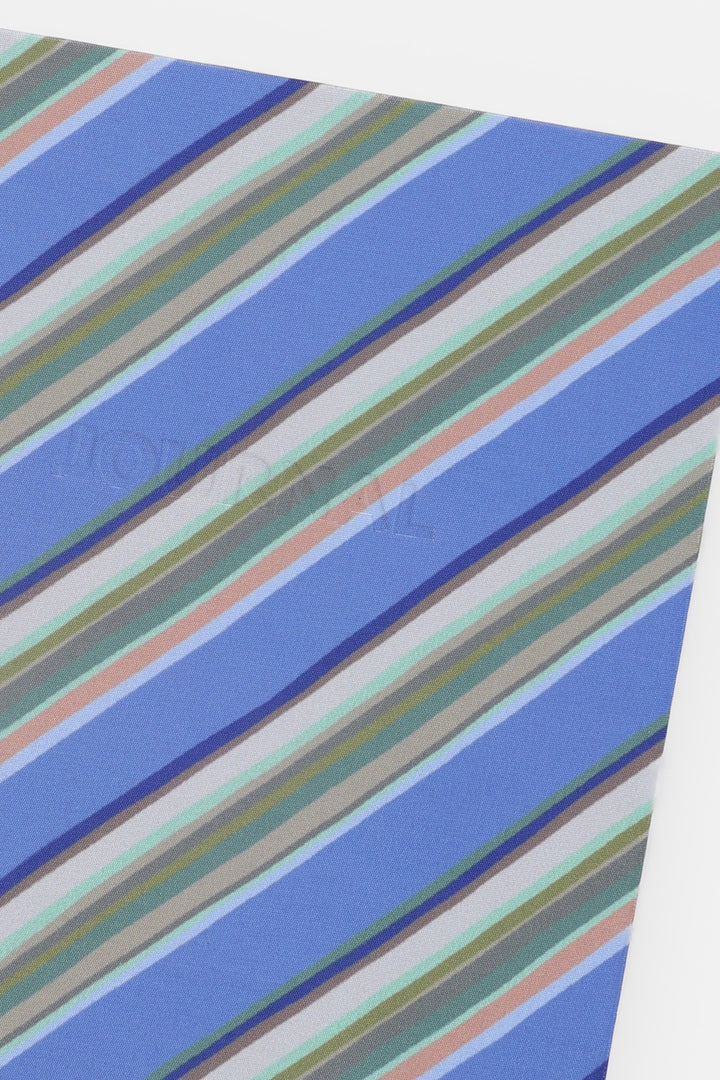 Close-up of a fabric with blue, green, and beige striped pattern
