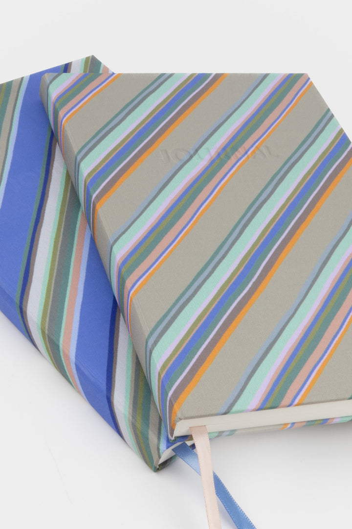 2 stacked a5 journal with blue and grey diagonal stripe fabric cover and embossed journal text