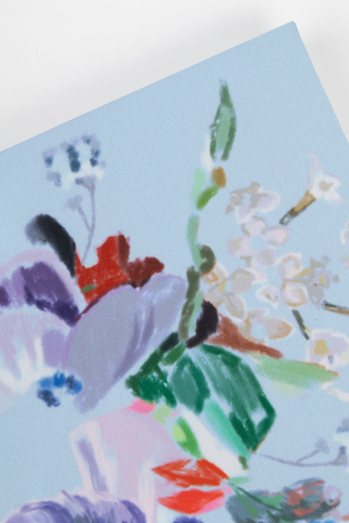 Colorful floral painted journal on a light blue background