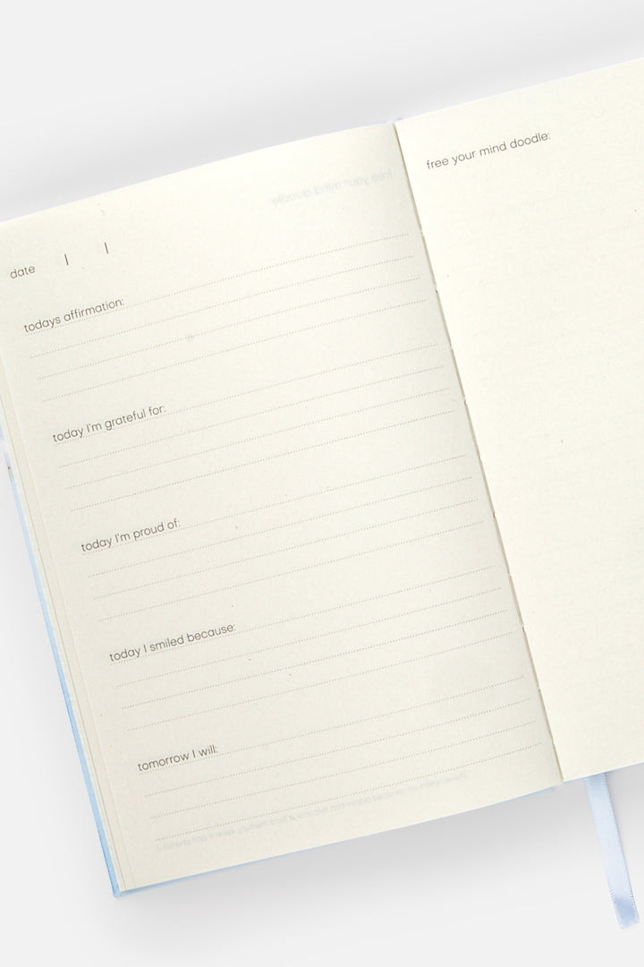 Open journal with lined and blank doodle pages on a white background