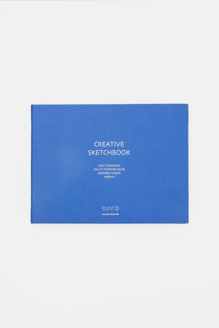 blue landscape sketchbook closed with white title on the cover