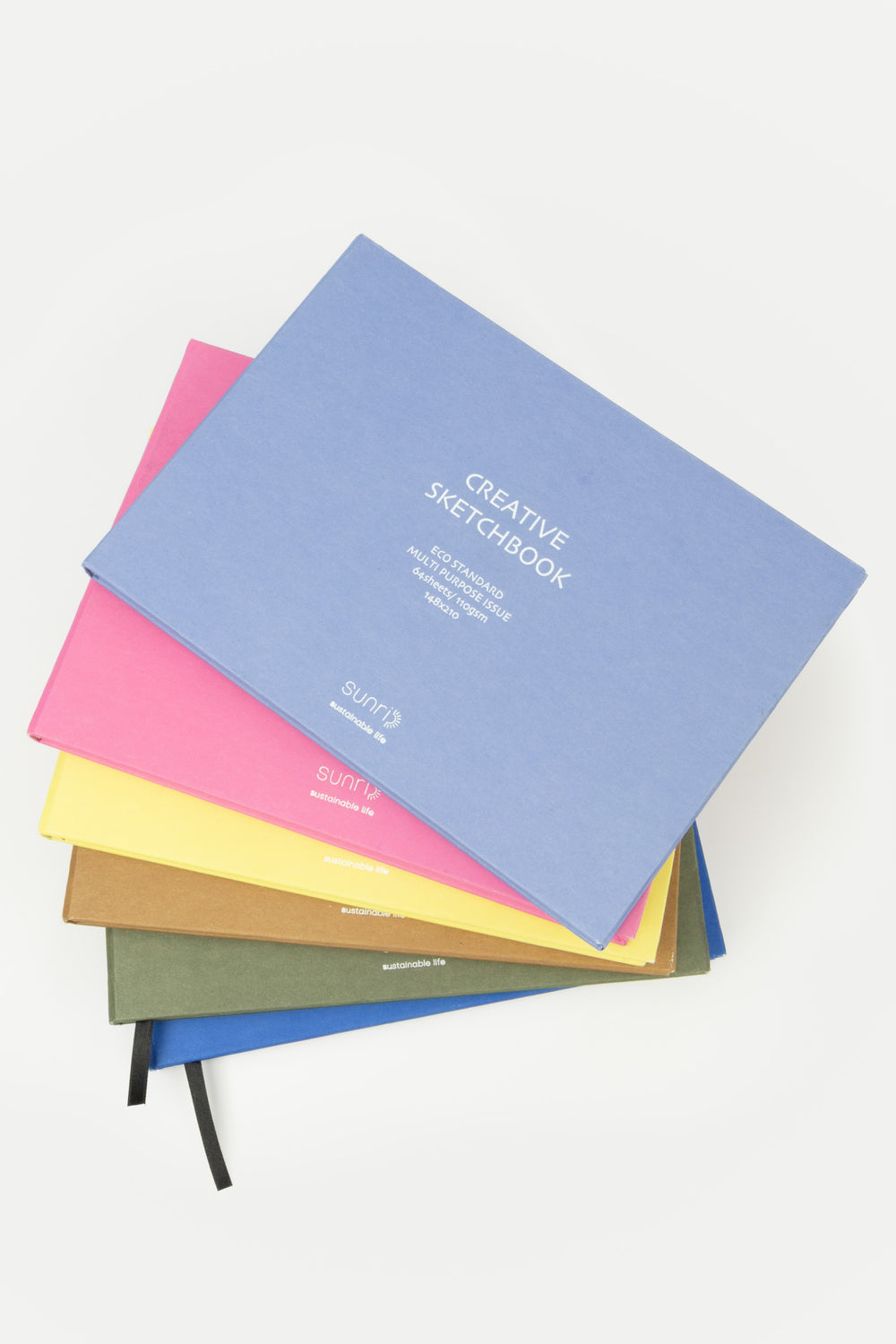 Stack of colorful sketchbooks on a white background