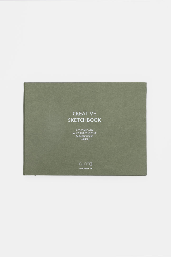 green landscape sketchbook closed with white title on the cover