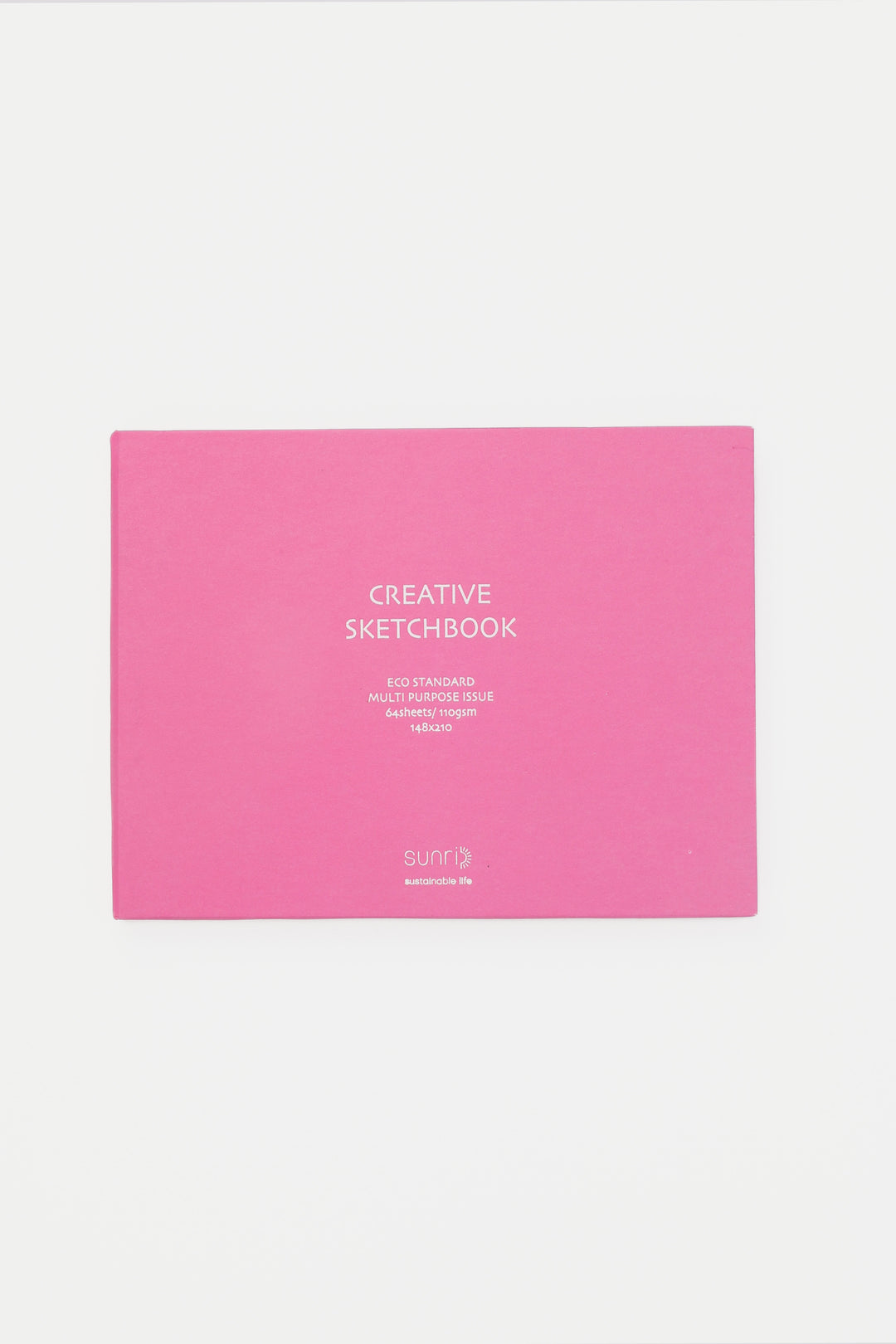 pink landscape sketchbook closed with white title on the cover