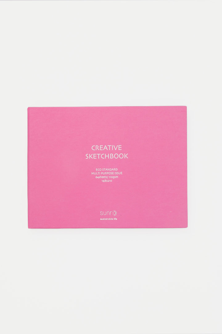 pink landscape sketchbook closed with white title on the cover
