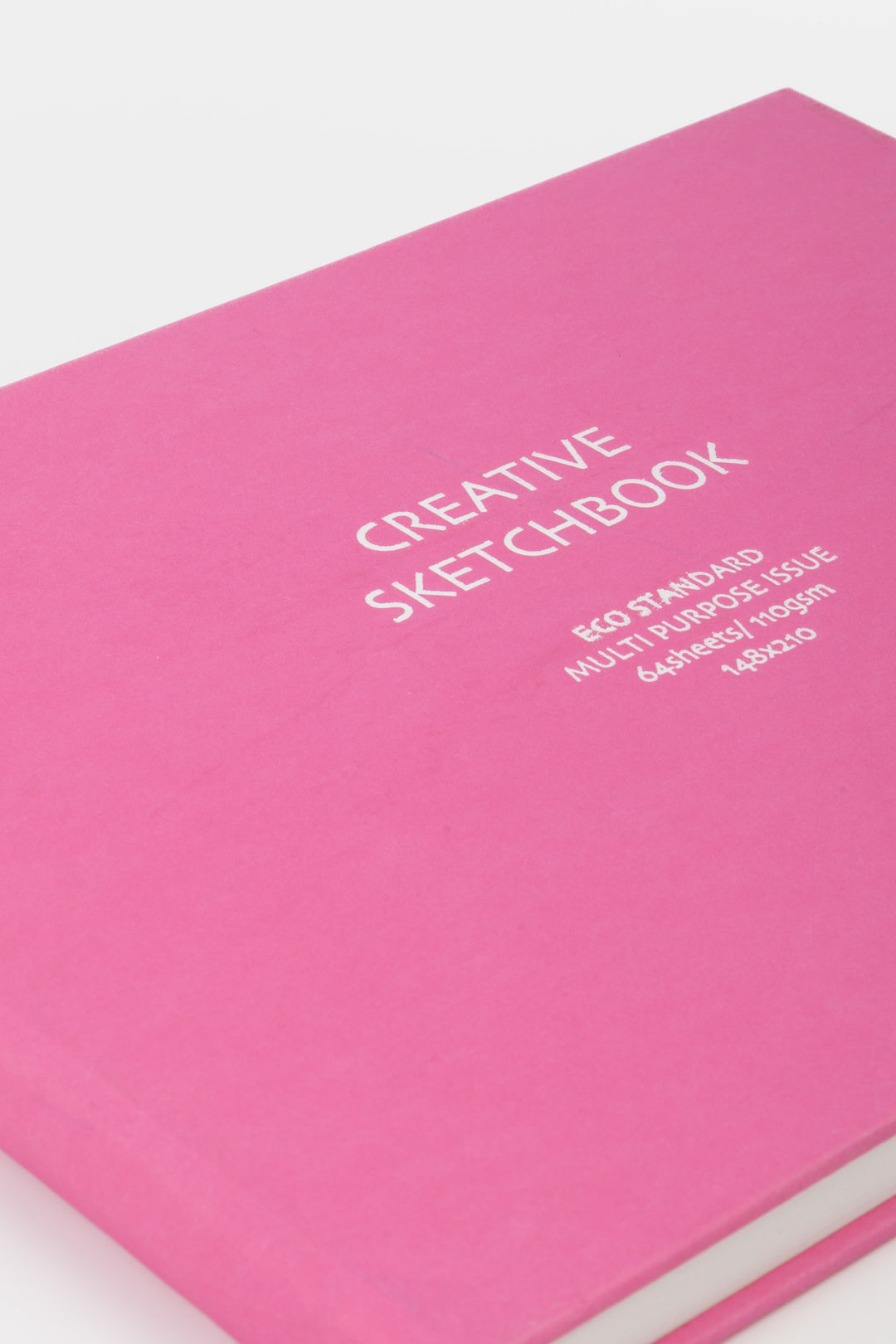 close up of the pink sketchbook cover with white printed title