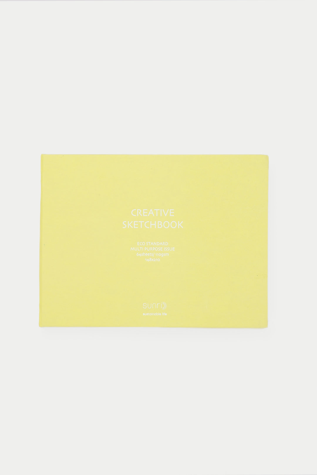 yellow landscape sketchbook closed with white title on the cover
