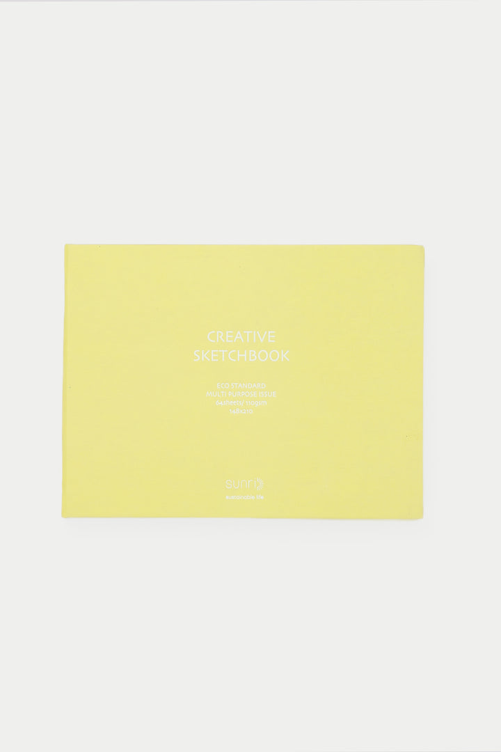 yellow landscape sketchbook closed with white title on the cover