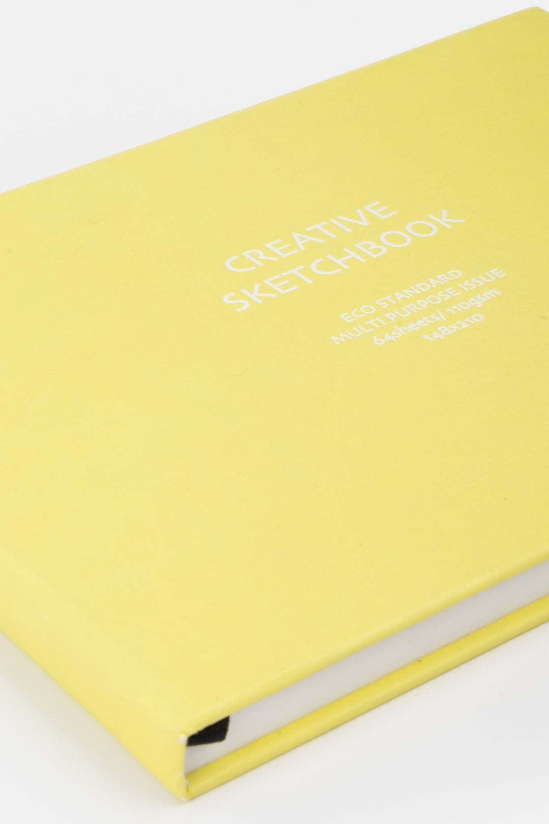 close up of the yellow sketchbook cover with white printed title
