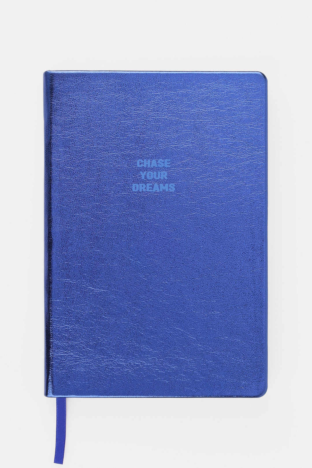 Closed blue metallic A5 notebook with chase your dreams text on the cover
