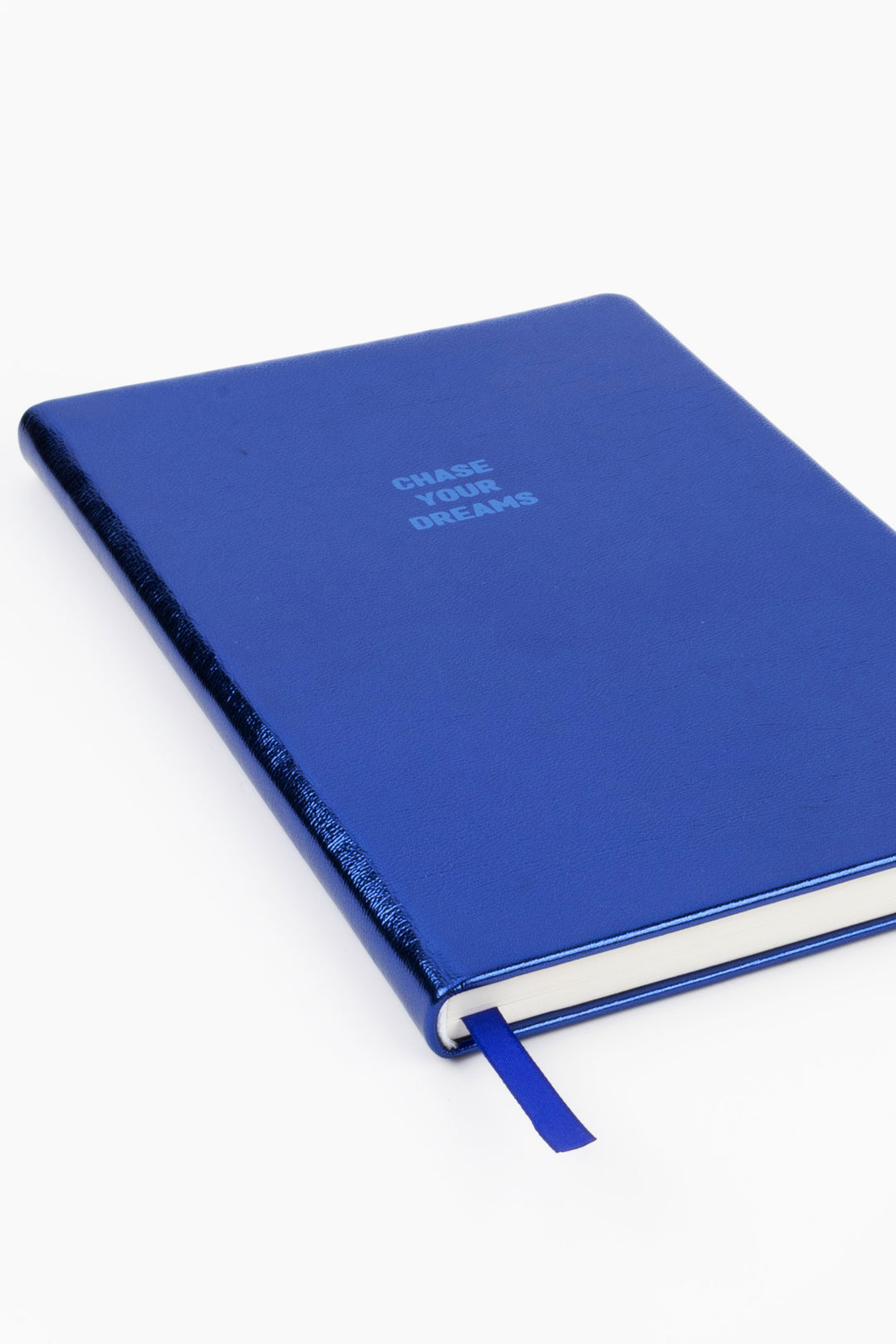 Angled view of closed blue metallic A5 notebook with ribbon marker
