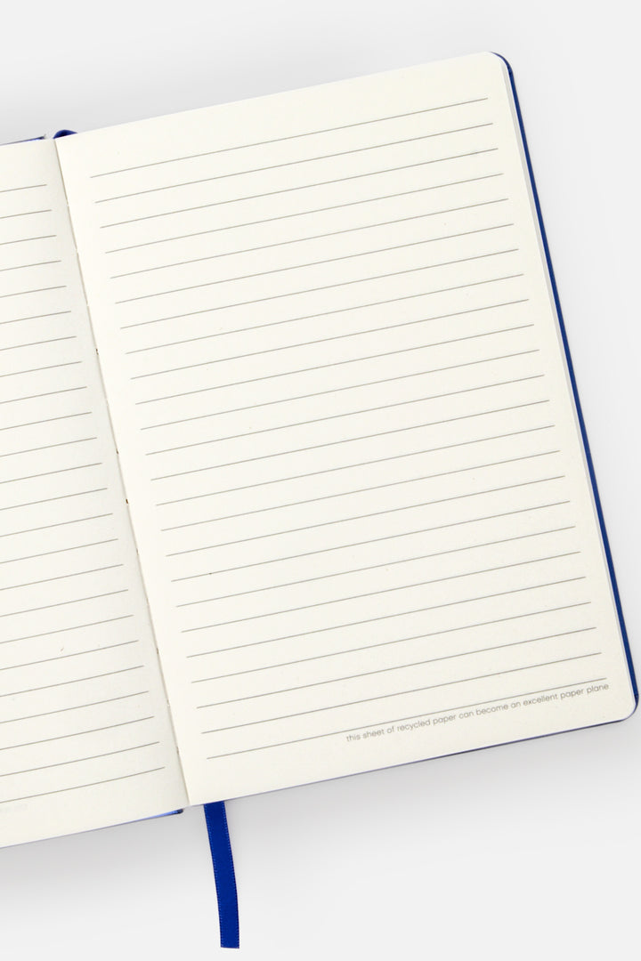 Open A5 notebook showing ruled pages with blue ribbon marker