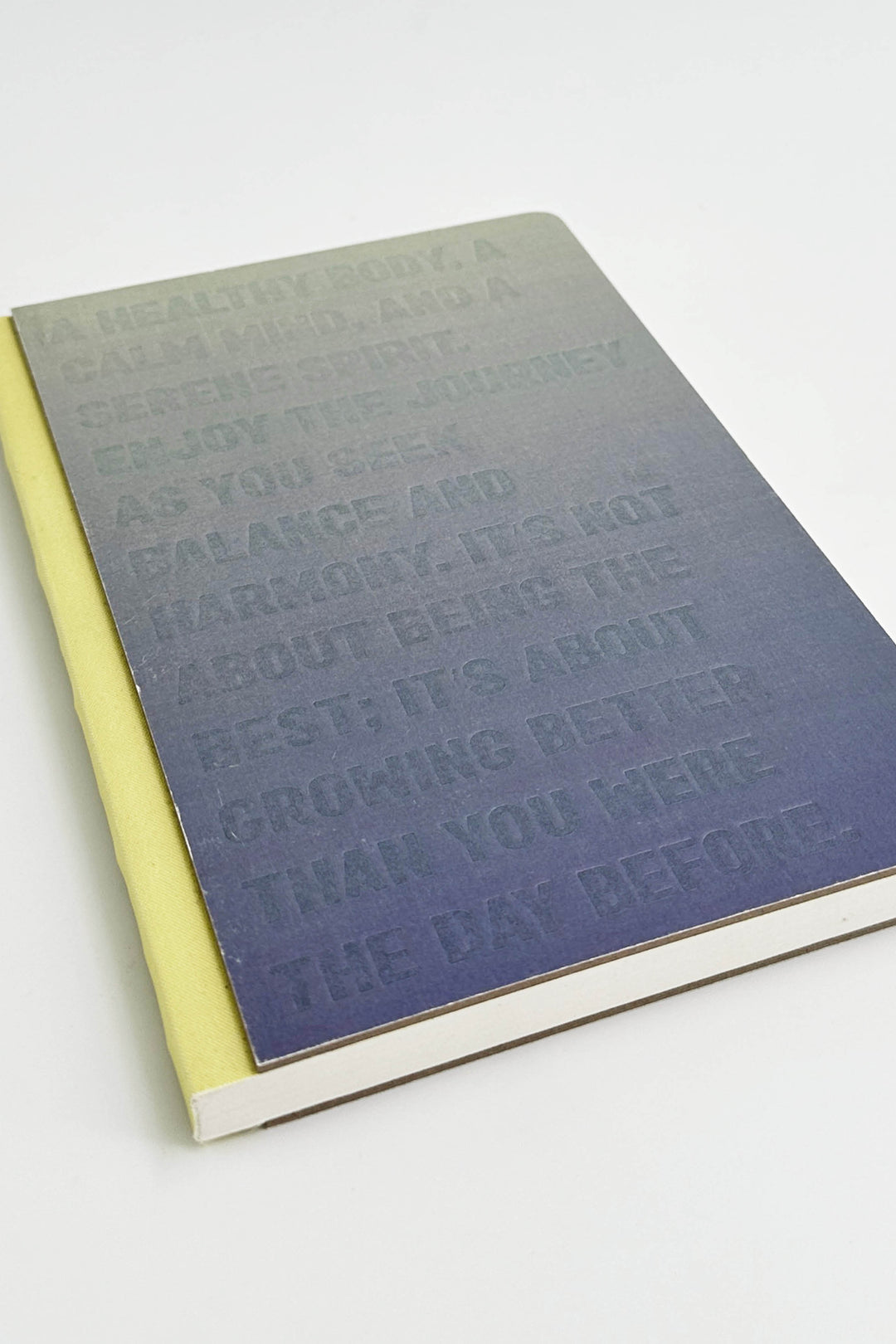 notebook with embossed text on a white background