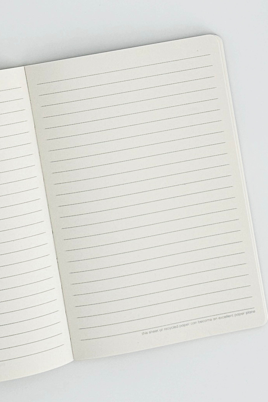 Open notebook with lined pages on a white background