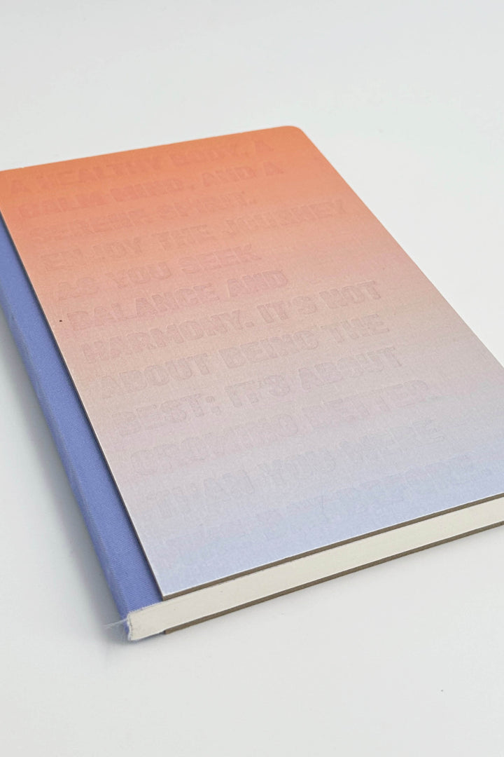 Gradient notebook with pink to blue color transition on a white background
