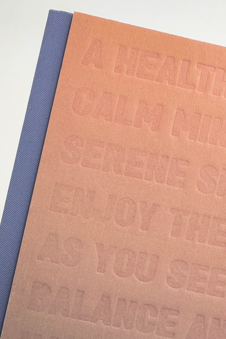 Textured notebook with embossed text on a white background