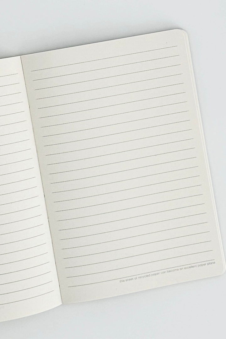 Open notebook with lined pages on a white background