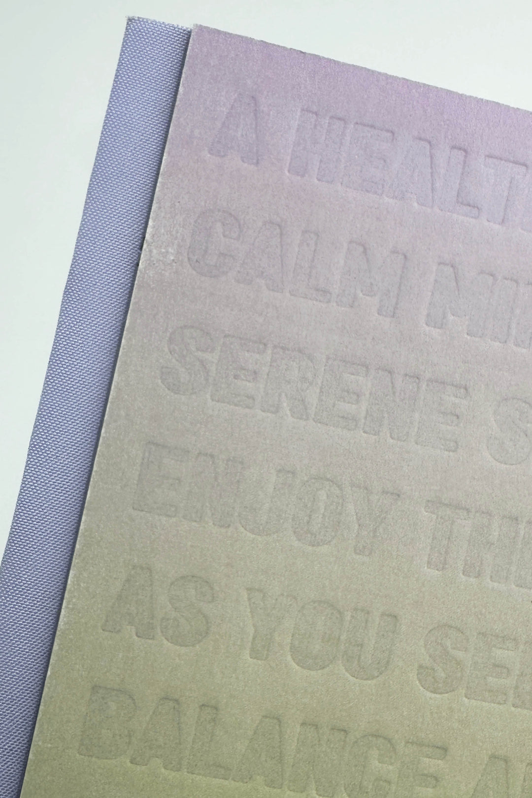 Textured notebook with embossed text on a light background