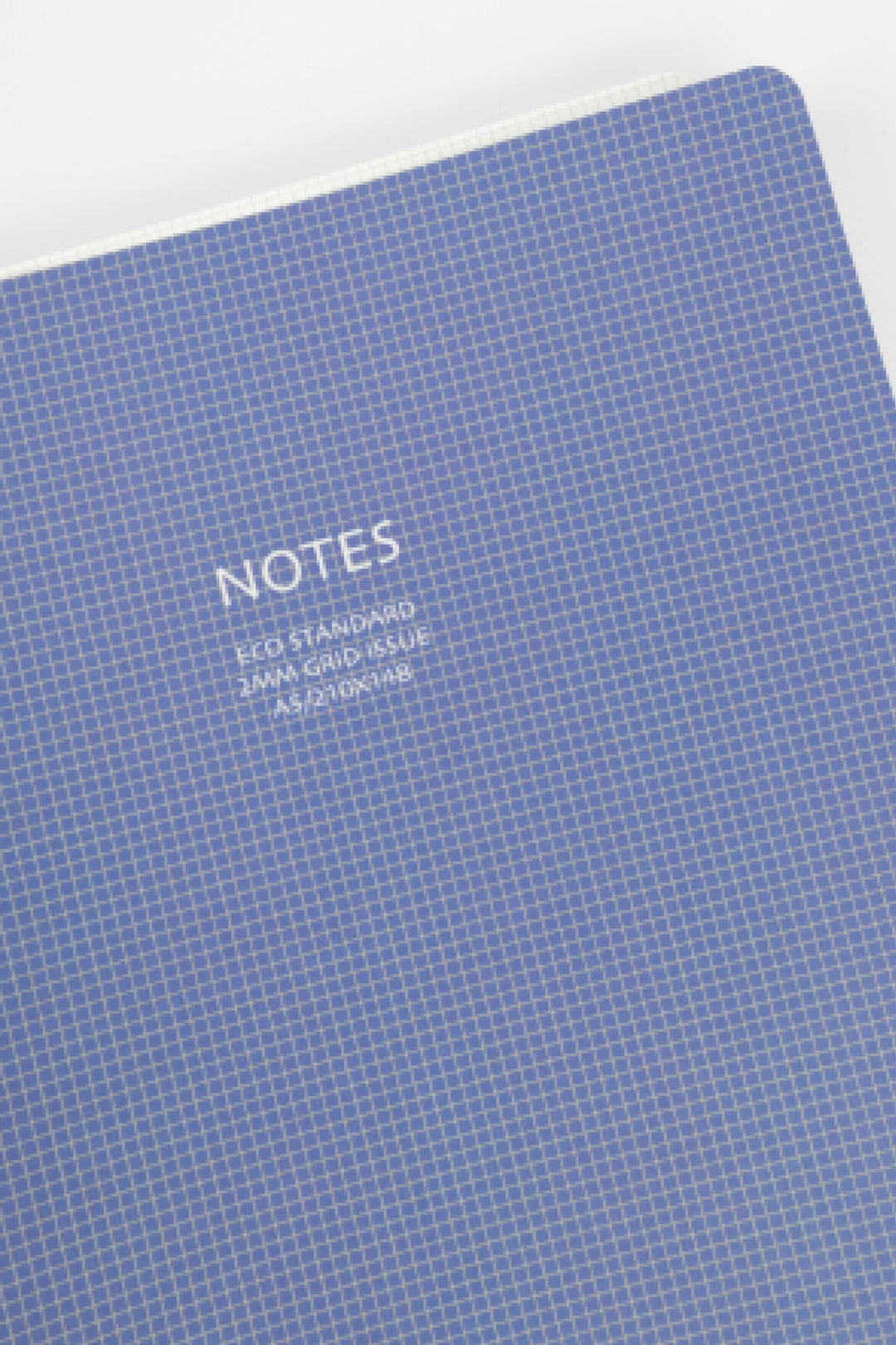 Blue notebook with grid pattern and 'NOTES' text on a white background