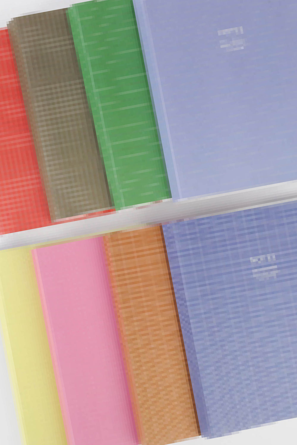 Set of colorful notebooks with grid and plain covers on a white background