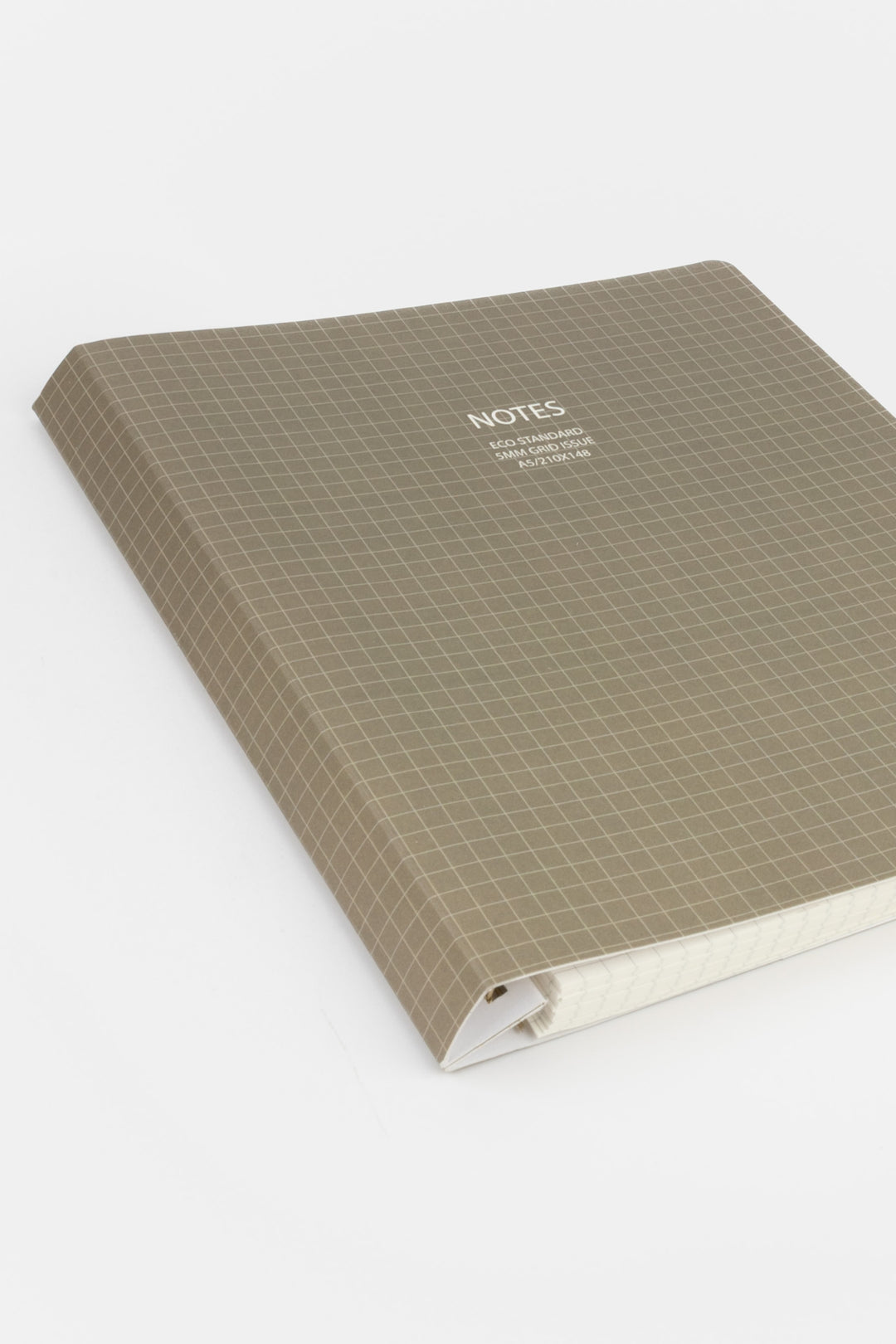 Angled view of a grey A5 notebook with a 5mm grid cover showing the spine
