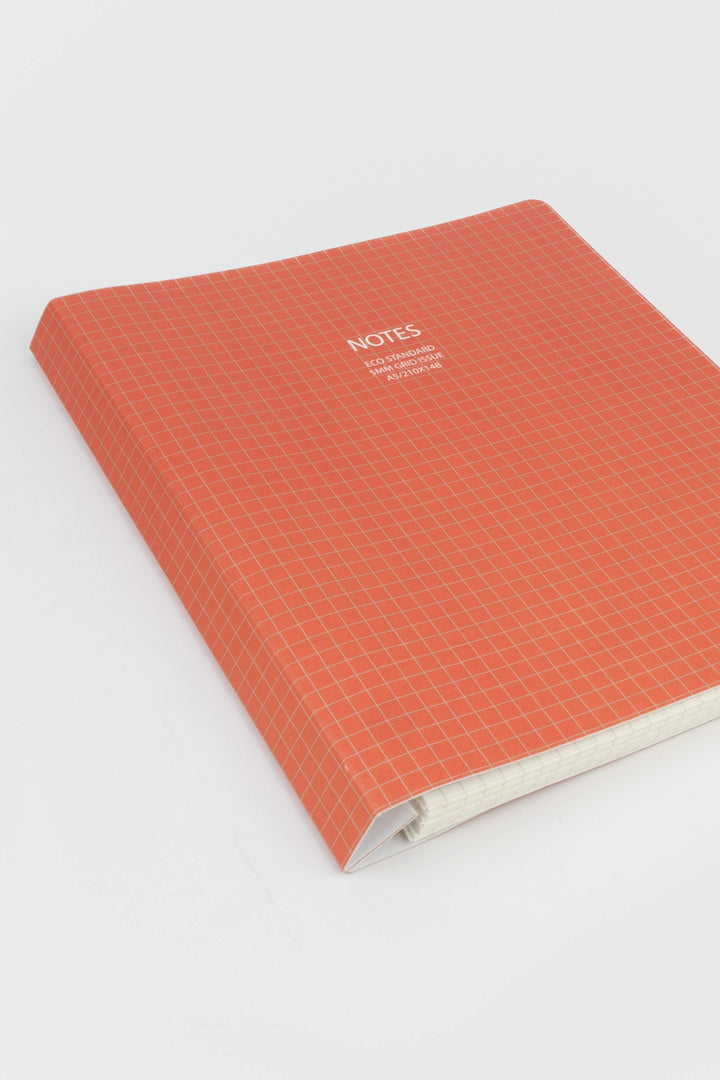 A5 softcover notebook with red 5mm grid cover angled view
