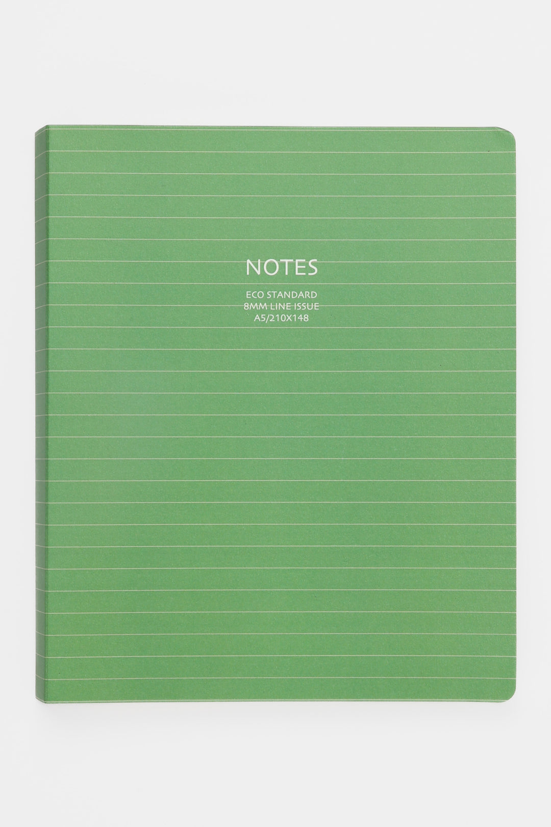 green A5 notebook with lined cover photographed front facing
