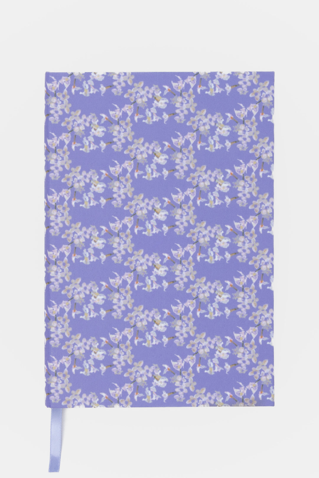 Floral-patterned notebook on a light purple background